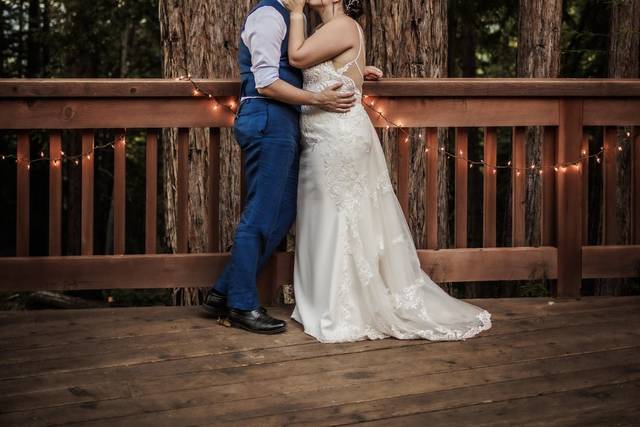 Bride and groom kiss outside.