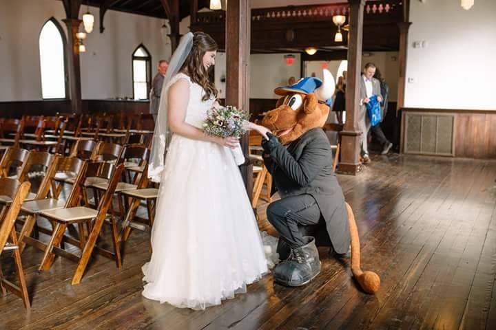 Mascot on bended knee