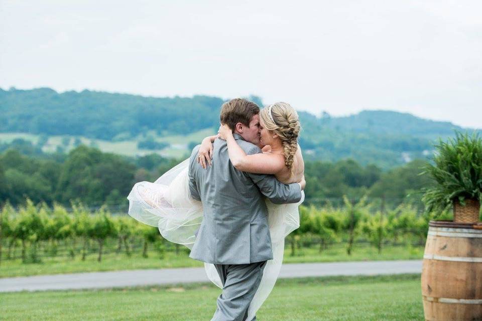 Groom carrying his bride