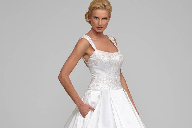 AmaliaSilk Gardenia Satin.  Ball gown with box pleated skirt and cathedral length train.  Chandelier and floral beading adorn the drop waist bodice with curved neckline, beaded straps, and cathedral train.