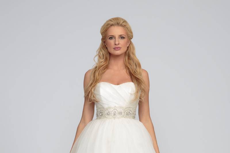 AnneSilk organza.  Gathered ball gown with cathedral length train.  Sweetheart neckline and draped natural waist organza bodice.  Natural waist and train are accented with crystal beading appliques.