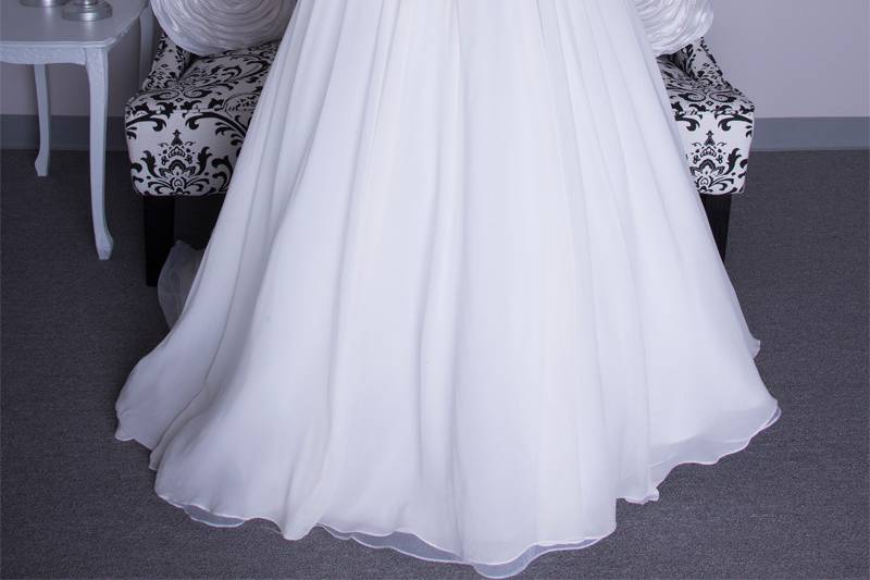 Chloe	Silk Chiffon. Ball gown with gathered skirt and cathedral length train.  Strapless sweetheart neckline with natural waist and draped bodice.  Gown is accented with crystal beading and floral detail at natural waist and three dimensional detail.