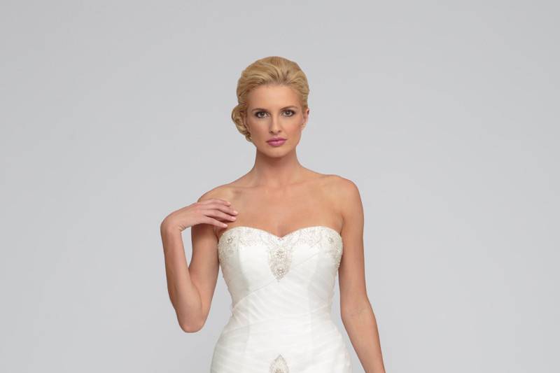 Anastasia Organza.  Fit to flair gown with layers of frothy organza raw edge ruffle detail.  Strapless sweetheart neckline.  Asymmetric crisscross pleated bodice accented with delicate beading at neckline and drop waist.  Cathedral length train.