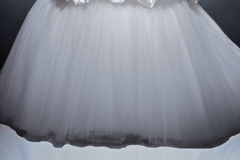 Astrid	 Silk Empress Satin & Tulle.  Dropped waist ball gown with bubble hem and tulle skirt.  Strapless sweetheart neckline with cathedral train.  Accented with hand embroidery and crystal beading.  Tulle removes and turns into a mini skirt for the reception.