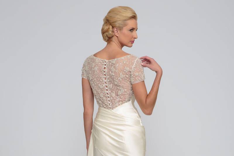 Candace  Silk Charmeuse.  Sheath gown with draped asymmetric waist line.  Sweetheart neckline and draped bodice.  Bodice accented with beaded illusion sleeves and back.  Chapel length train.