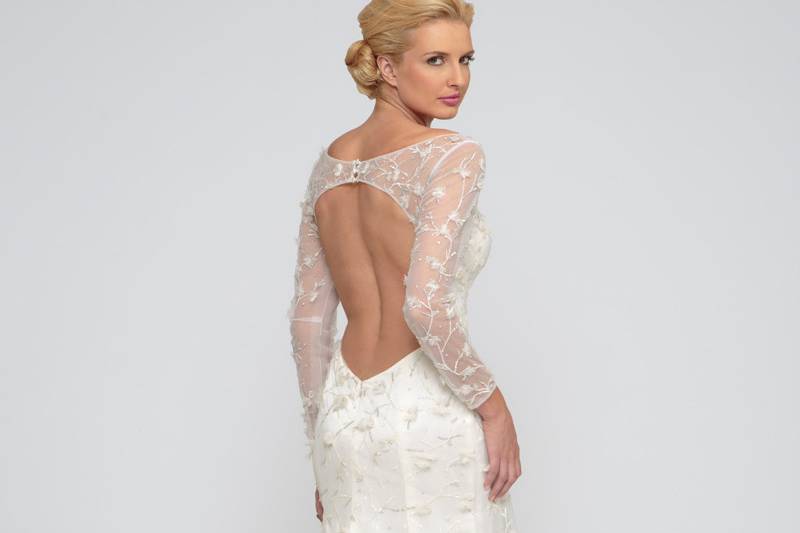 Eleina  Silk charmeuse.  Floral sequin embellished tulle.  Sheath gown with illusion sweetheart neckline and long sleeves.  Key hole accentuates the back and godet sweep train completes the look of the gown