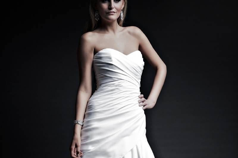 Michelle  Regal Satin.  Modified A-Line Gown with chapel train.  Strapless dropped waist with draped body and stufted draped front