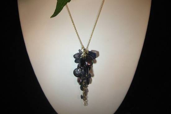 BRITTANY/$98.- A beautiful array of richly textured indigo colored stones including coin pearls and faceted and smooth iolite on a simple goldtone chain-16