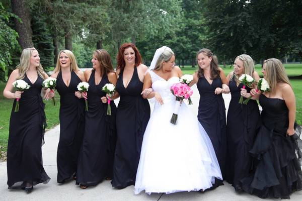 The bride takes a moment to have fun in front of the camera with her bridesmaids