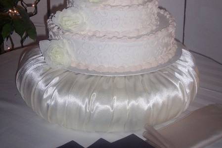 3 tier wedding cake with champaign flute as topper.
