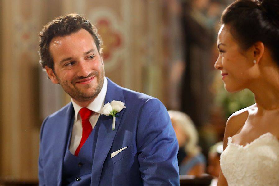 The groom smiling at his bride