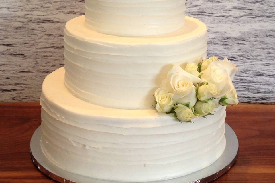 Three tier wedding cake with white flowers