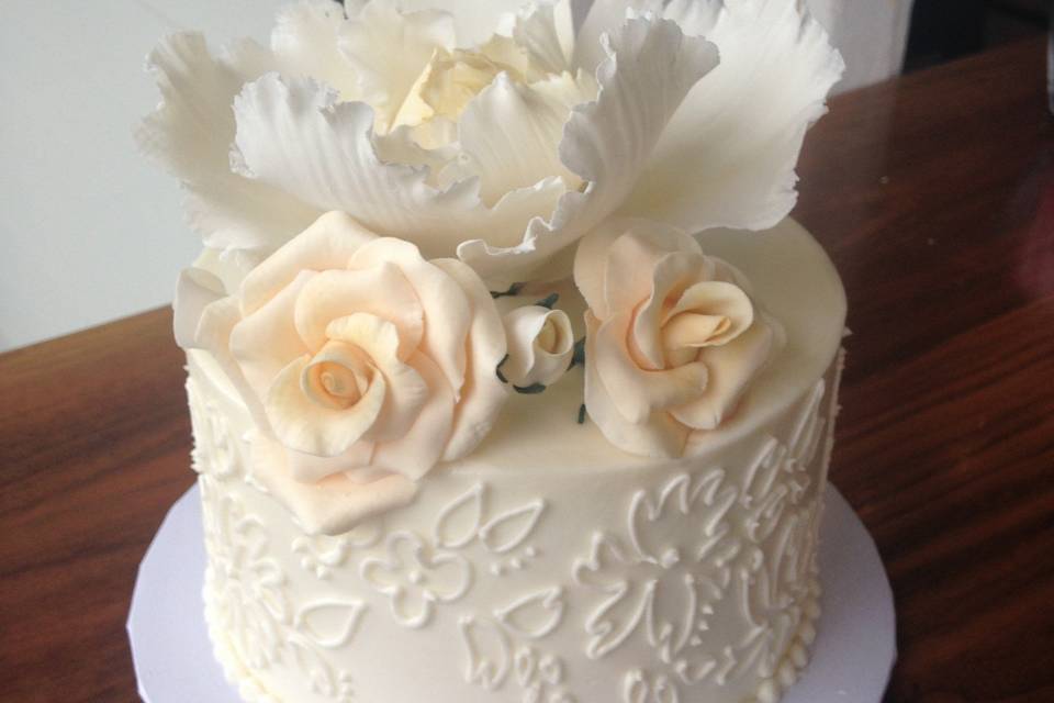 White cake with flowers on top