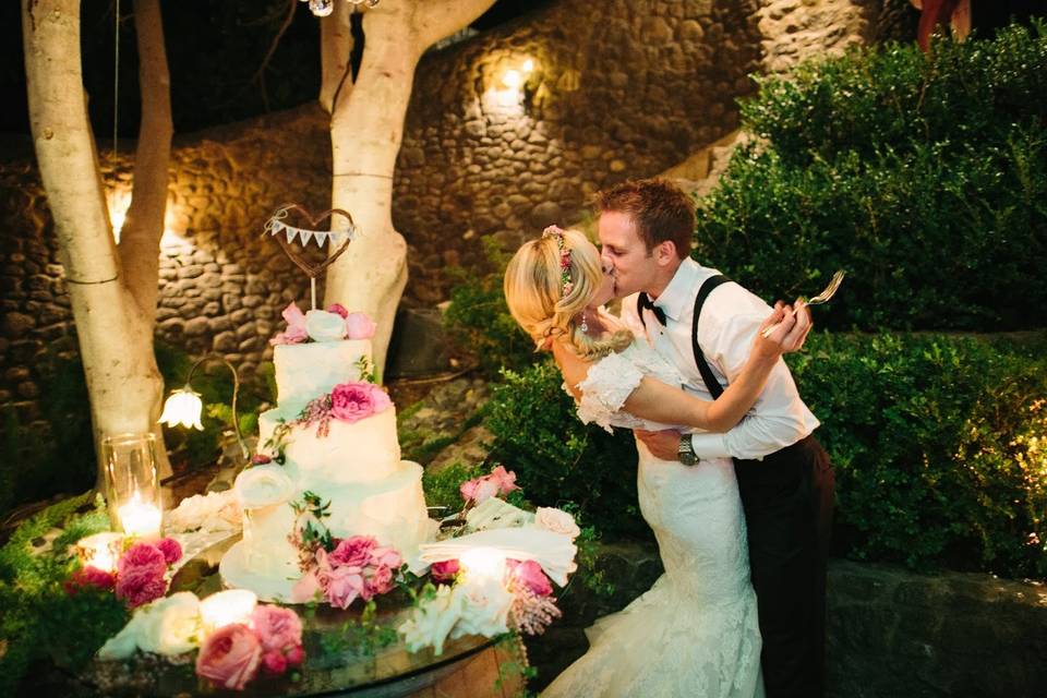 Kissing couple beside cake