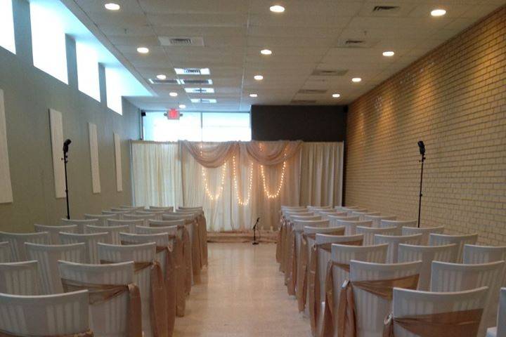 White chairs with gold ribbons