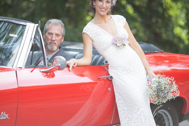 Newlyweds by the car