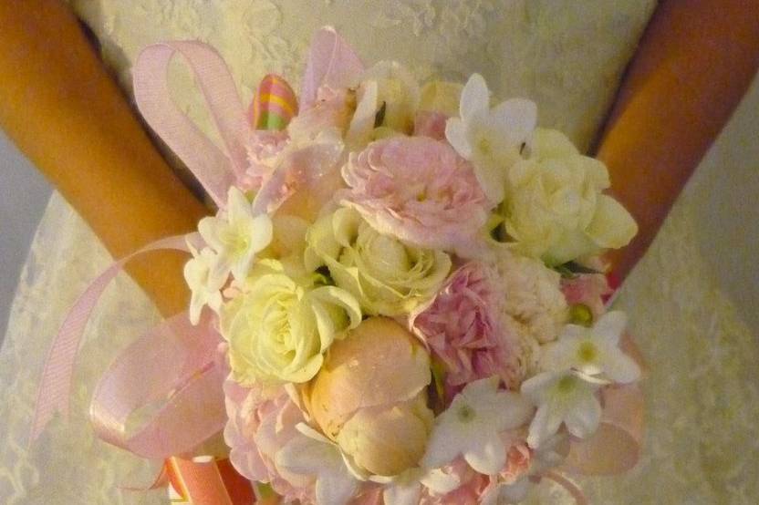 Purple feathers are the attraction in this bouquet made up of purple button mums, Porcelini spray roses, and white alstromeria