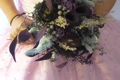 Only three flowers made up this wonderful bouquet: Concodor lily blossoms, purple lisianthus, and Polar Star roses...finished with italian ruscus greens.