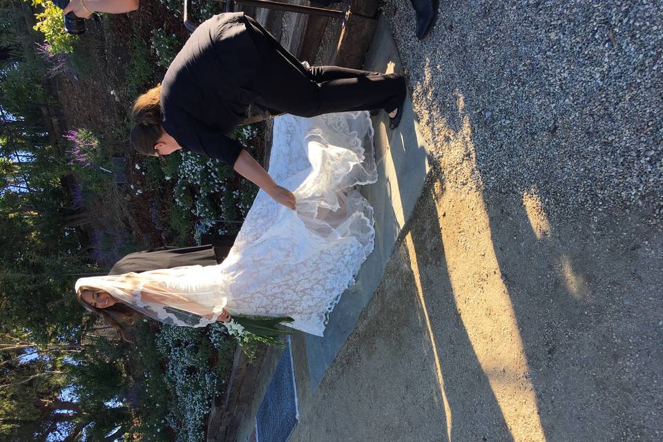 Lana Meadows Events staff fixing Rachel's train right before she walks down the aisle.