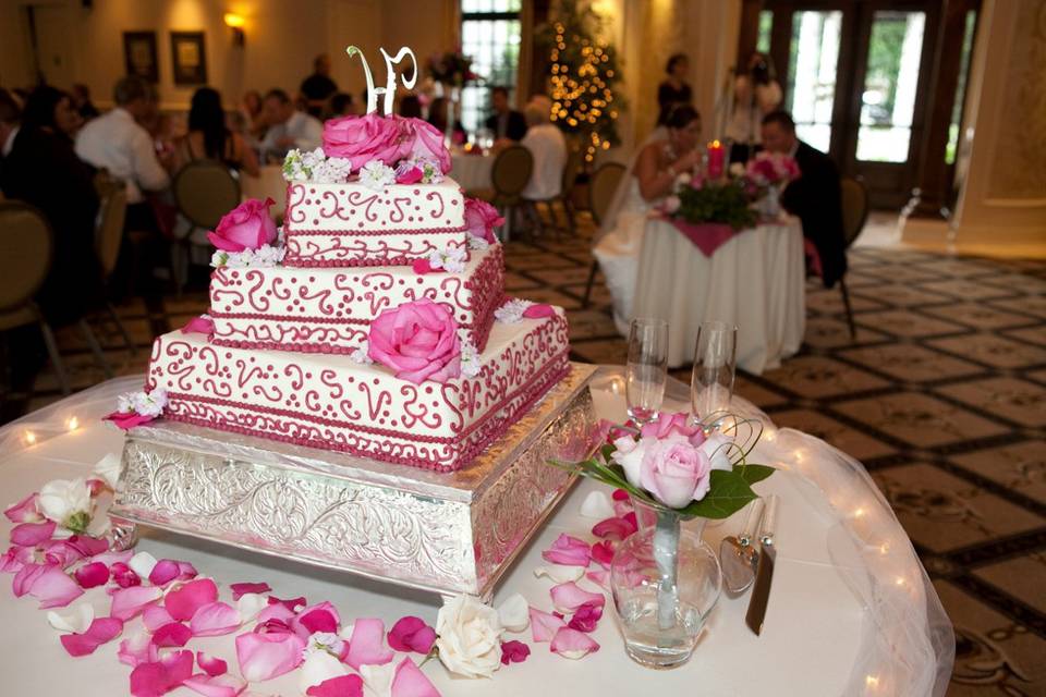 A very pretty wedding cake with an initial topper.