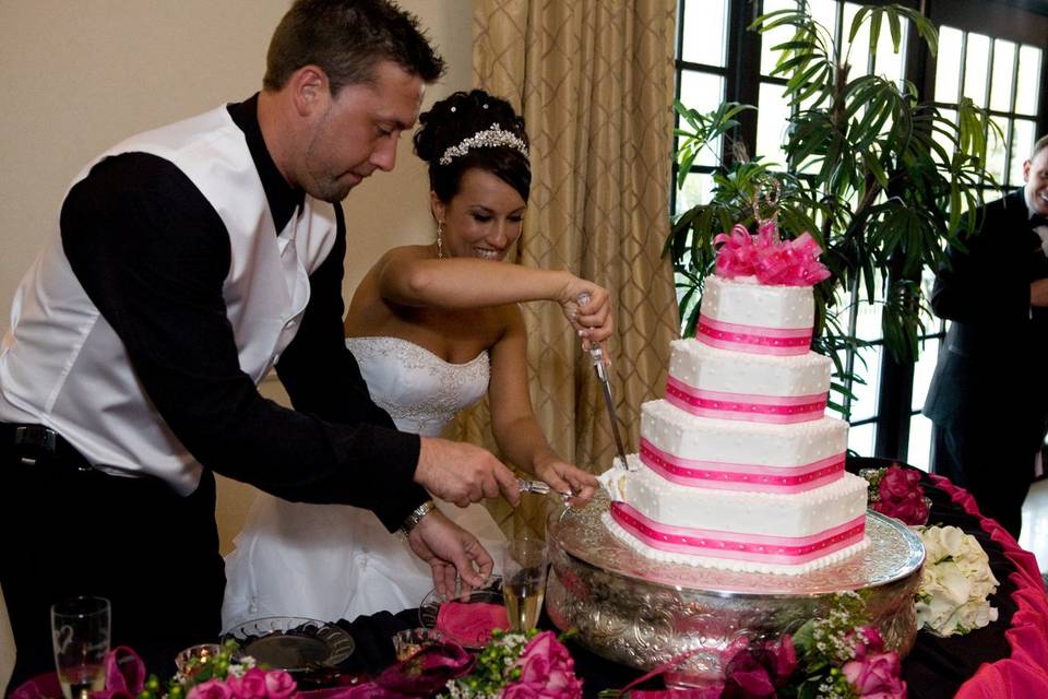 The happy couple cutting their cake.