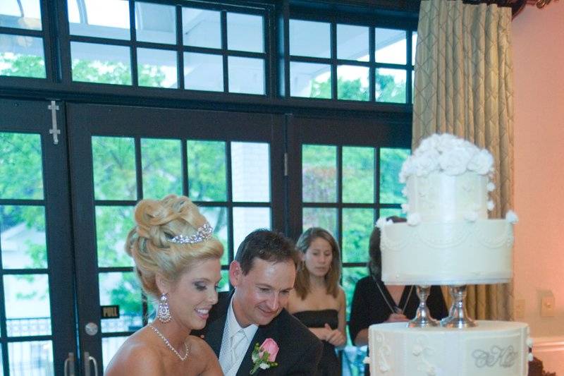 Happily cutting into their cake.