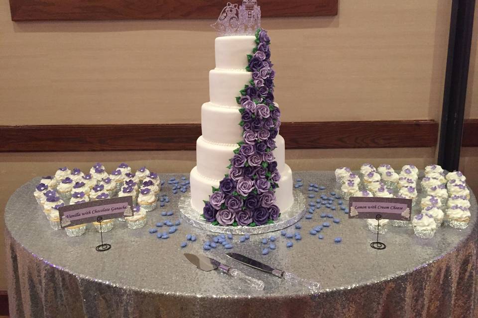 Tall wedding cake with purple flowers