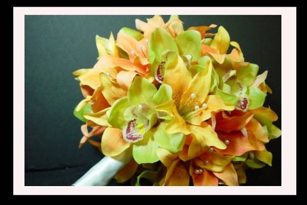 This bouquet is made of yellow and orange lilies mixed with green orchids. It is stylish and modern!