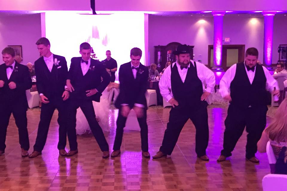 The groom with his groomsmen dancing