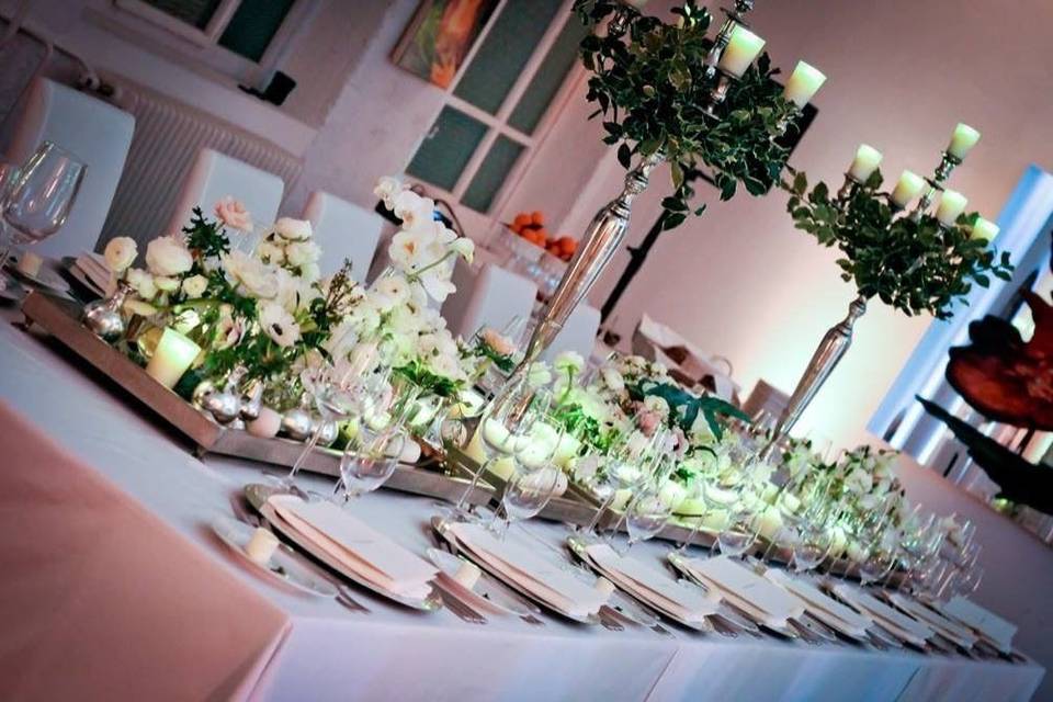 Long table setup with flowers and candles