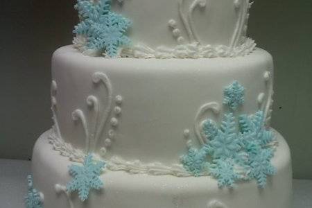 Perfect winter wedding cake with light blue and white fondant snowflakes.