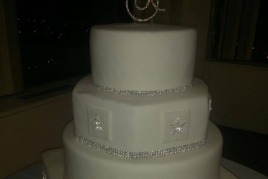 Round, Hexagon and square.  Fondant covered cake with silver snowflakes and rhinestone beading at bottom of each tier.