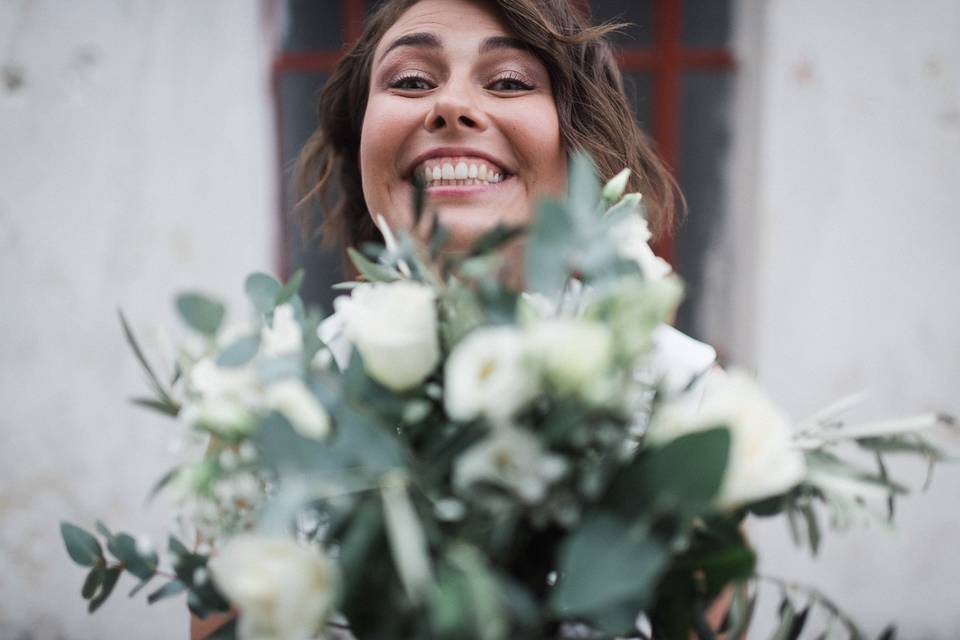 Bride hiding behind bouquet