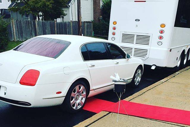 Cross County Limousine providing luxury service. Red carpet, champagne toast and Bentley luxury for the couple, plus the party bus for the bridal party