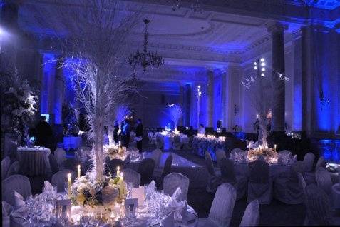 Ice blue uplighting and pin spots on the centerpieces