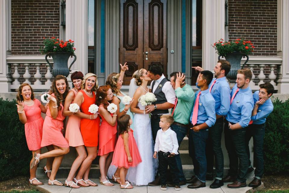 The couple with the bridesmaids, groomsmen and kids at the wedding