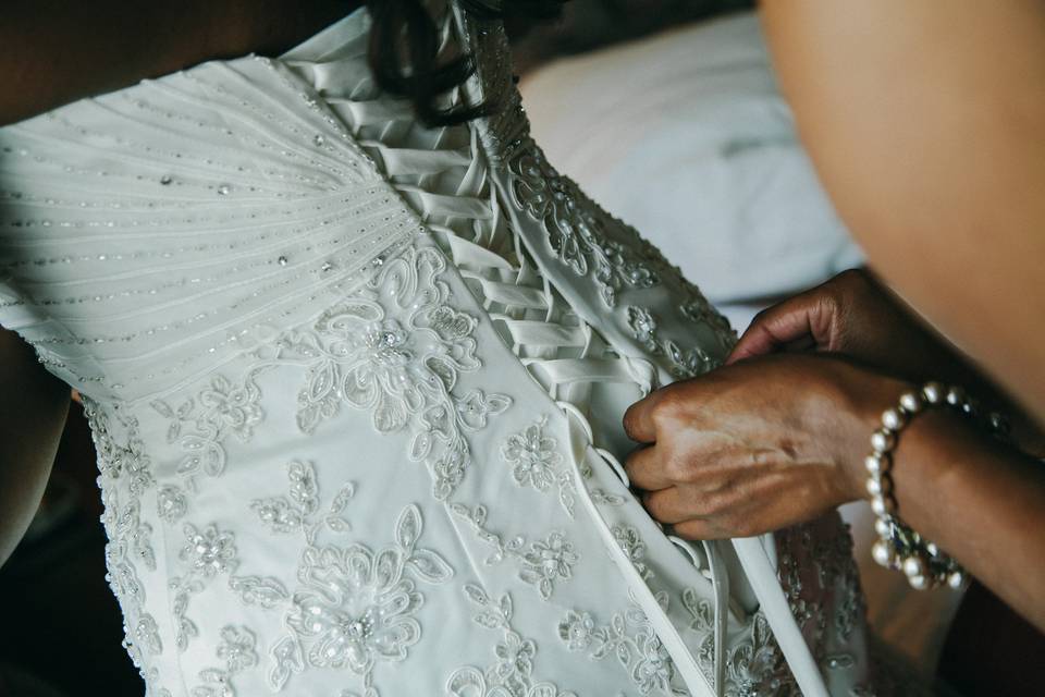 Details matter. Bride getting laced up. Such a beautiful gown. Photo credit: BM-Photography