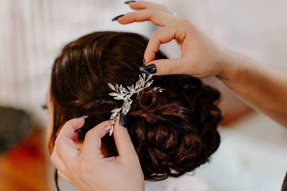 Wedding updo with white hair accessory