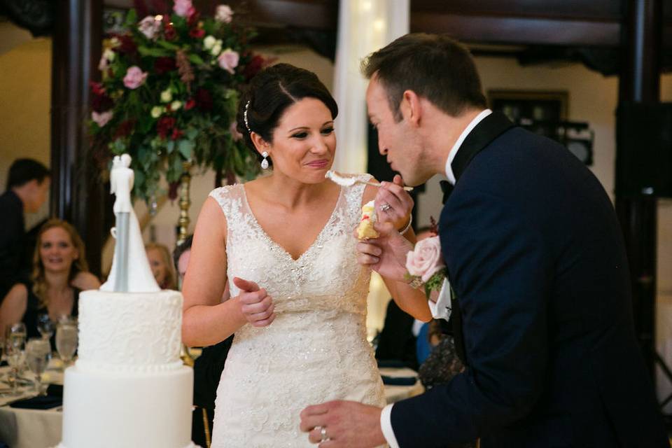 Emily and Robert tasting  their wedding cake (Michael Novo Photography)