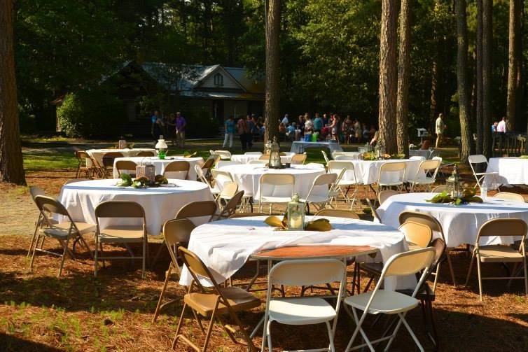 Reception tables set up under the pines