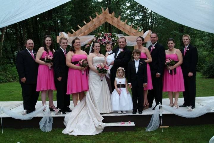 Bridesmaids kissing the groom on the cheek