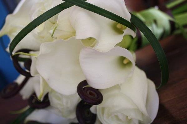 Calla lily, roses and monkey tail with  bear grass details - bridal bouquet.