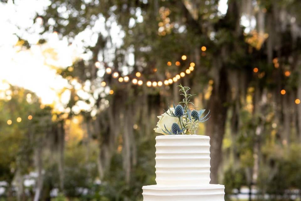 Outdoor cake display with thistle decorations