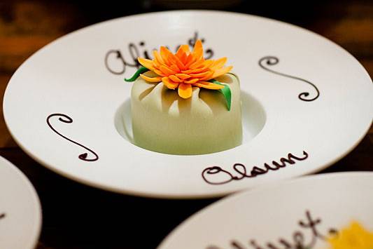 Individual cakes with hand crafted flower on personalized plates! Done with chocolate of course