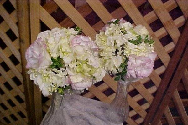 Modest size bridesmaids bks. A sweet  combination of white hydrangeas, pink and white sweetheart  roses,  bicolor pink lisianthus,myrtle, ming fern .