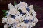 roses, stephonotis, steel blue thistles make a unique  round  bridal bk.