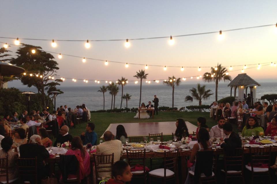 The sun setting over the ocean as the toasts begin