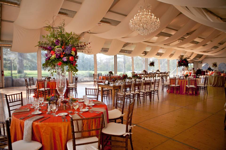 Orange tables and raised floral centerpiece
