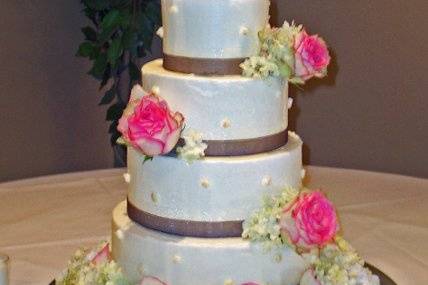 A beautiful five tiered wedding cake sitting upon a 20