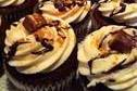 Snicker flavored cupcakes!  Chocolate cupcakes filled with caramel.  Topped with buttercream, a swirl of ganache, caramel and a chucnk of snickers